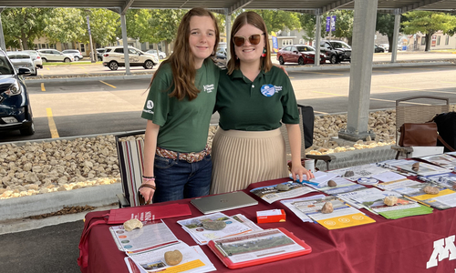 Katilynn Swanson and fellow Climate Impact Corps member table at an event